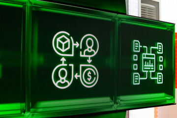 Close up of digital screen displaying icons related to business, finance, and technology. Green background and arrows symbolize data flow, transactions, and communication in modern digital economy