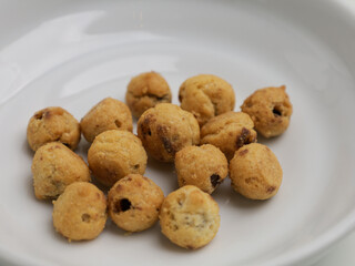 Choux pastry cookies with chocolate filling on white background