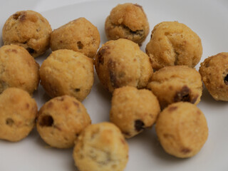 Choux pastry cookies with chocolate filling on white background