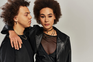 Fashion forward young couple sharing a moment of style and connection in a modern studio setting