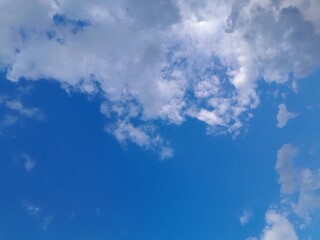 Background with clouds on blue sky. Beautiful sunny sky