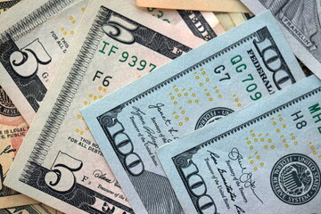 Big amount of different dollar bills close up. Hundred fifty twenty ten and five dollar banknotes