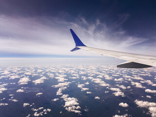 №8  08.2025
View from airplane window to airplane wing, and clouds from above the sky.