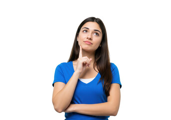 Young woman with long dark hair wearing a blue tshirt, thinking with her finger on her chin, isolated on transparent background