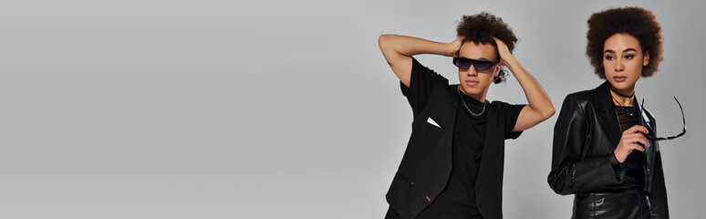 Young fashionistas showcase unique styles with curly hair and bold accessories in modern setting