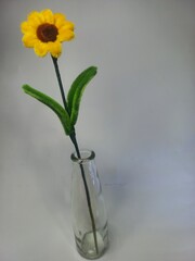 Decorative sunflowers in a transparent vase isolated on a white background. Modern minimalist interior concept. Close-up. Copy space. Selective focus.