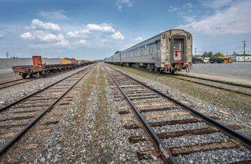 Obraz premium Passenger train and freight train on train tracks at Thompson, Manitoba, Canada
