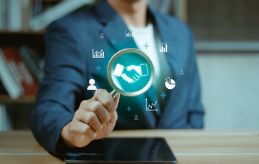 Trustworthy collaboration, company or contract. Confidence to work together. Businessman use Magnifying glass finding shake hand icon. Build trust in business finance relationships.