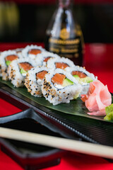 a sushi roll is seen on a red table at a restaurant