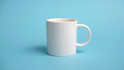 Obraz premium Clean white ceramic mug with handle displayed on a vibrant blue surface