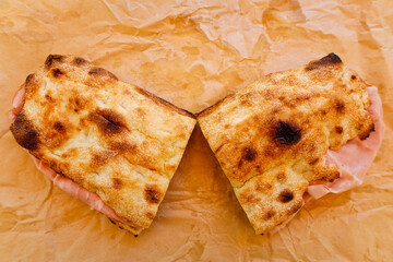 Traditional Italian focaccia sandwich filled with mortadella, photographed on parchment paper in Rome, Italy, August 2025