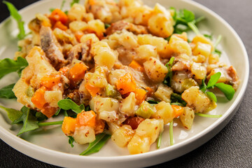 Potato salad with smoked fish tasty snack fresh delicious gourmet food background on the table rustic food top view copy space