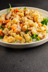 Potato salad with smoked fish tasty snack fresh delicious gourmet food background on the table rustic food top view copy space