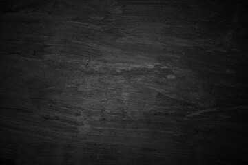 Dark grungy textured surface with strokes and imperfections. Suitable for background design projects, digital art, or textures.