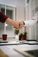 A corporate team collaborates in an office, analyzing financial reports and charts. They discuss strategy, investment, and planning to achieve growth, innovation, success, and long-term business perfo