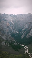Serene Tibetan Mountain Valley Landscape in Gannan with Winding River and Prayer Flag Colors in Sky