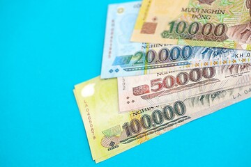 Vietnamese dong money bills in big amount on blue. Finance and banking concept