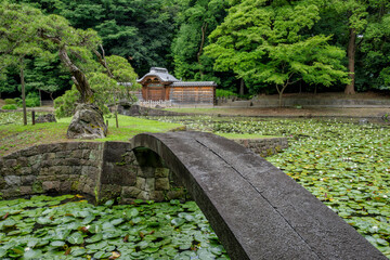 Two stone bridges lead to a gate, Kara-mon, which separates the Koishikawa Korakuen Inner Garden from the rest of the park. Bunkyo city, Tokyo, Japan. 