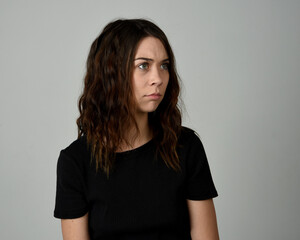 Fototapeta premium Brunette Girl Model Head and Shoulders Studio Portrait Fresh Faced and Pretty Showing expression emotional upset Expressions