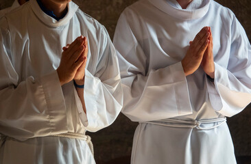 Altar boys praying during a Mass