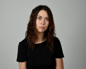 Obraz premium Brunette Girl Model Head and Shoulders Studio Portrait Fresh Faced and Pretty Showing expression emotional upset Expressions