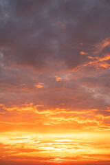 Fototapeta premium Beautiful , luxury soft gradient orange gold clouds and sunlight on the blue sky perfect for the background, take in evening,Twilight, Large size, high definition landscape photo,Vertical