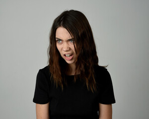 Obraz premium Brunette Girl Model Head and Shoulders Studio Portrait Fresh Faced and Pretty Showing expression emotional upset Expressions