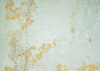 Crumbling plaster and paint on a wall as an abstract background.