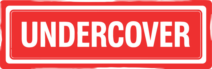Bright red rectangular sign with white border and the word undercover in bold white lettering
