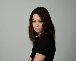 Obraz premium Brunette Girl Model Head and Shoulders Studio Portrait Fresh Faced and Pretty Showing expression emotional upset Expressions