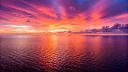 Vibrant sunset over a calm ocean with dramatic sky