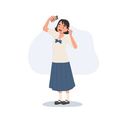 asian teenager girl in school uniform smiling and posing for selfie with mobile phone capturing lifestyle technology