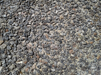 Small rocks in concrete light close up. Crushed stone road and garden building gravel texture.