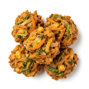 Golden brown vegetable fritters with visible ingredients on white background pakora snack