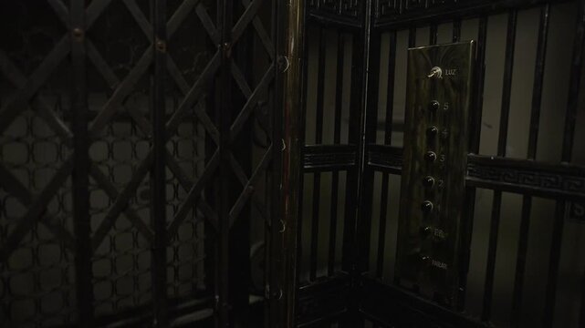 Old vintage elevator in a historic building with classic metal details and folding doors. Perfect for concepts of nostalgia, architecture and heritage.