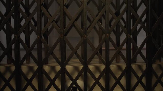 Old vintage elevator in a historic building with classic metal details and folding doors. Perfect for concepts of nostalgia, architecture and heritage.