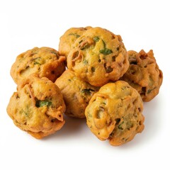 Pile of golden brown fried pakora fritters with green herbs food snack
