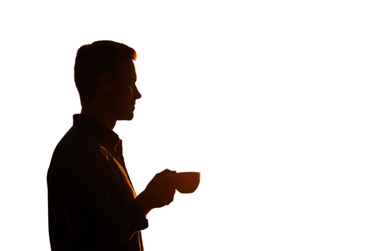 Silhouette of a man holding a cup, enjoying a quiet moment, backlit by warm sunset light.