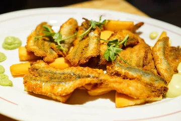 Fototapeten Ligurien Fried Anchovies with Panissa (Ligurian Chickpea Fritters) , Acciughe fritte con panissa、A specialty dish from Genoa in the Liguria region of Italy  © honey