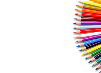 Colorful pencils fan. A vibrant array of sharpened colored pencils is spread out in a fan shape on the right side. Art, creativity, or education.