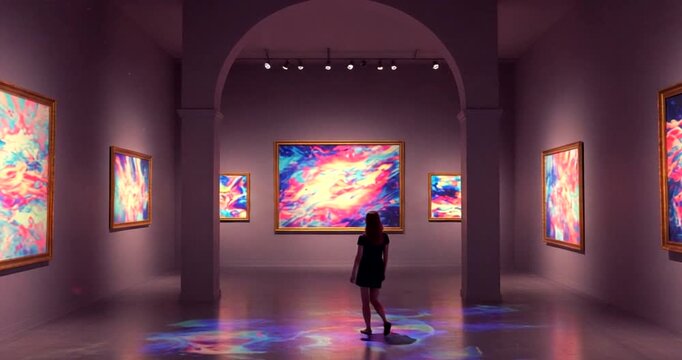 Woman admiring vibrant art in modern gallery space