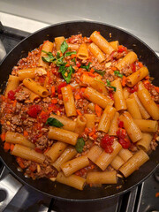 Rigatoni pasta with meat sauce in the pan.