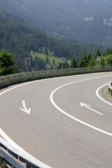 Scenic Alpine Mountain Road with Winding Curve and Forested Valley