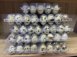 stack of quail eggs trays in the store