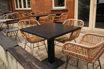 Wooden table and chair set in cafe on a sunny day,outdoor seating for restaurant or cafe.