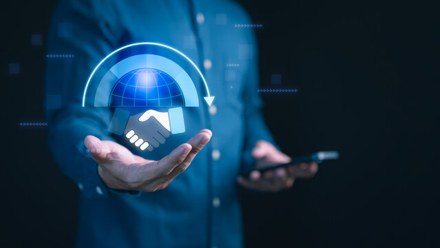Businessman holding digital of globe and handshake with circular arrow. Concept of global business partnership, online collaboration, international trade, networking, digital deal and teamwork.