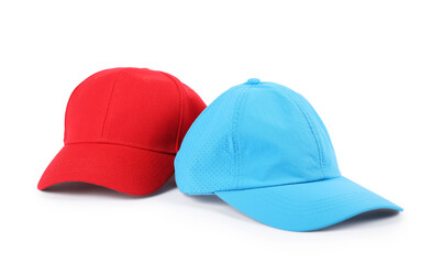 Red and light blue baseball caps isolated on white. Mockup for design