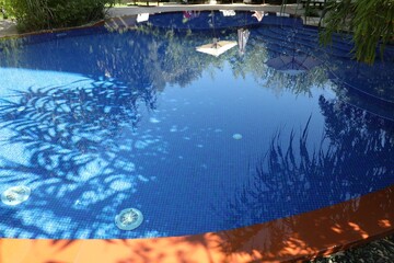 Outdoor swimming pool with clear water on sunny day