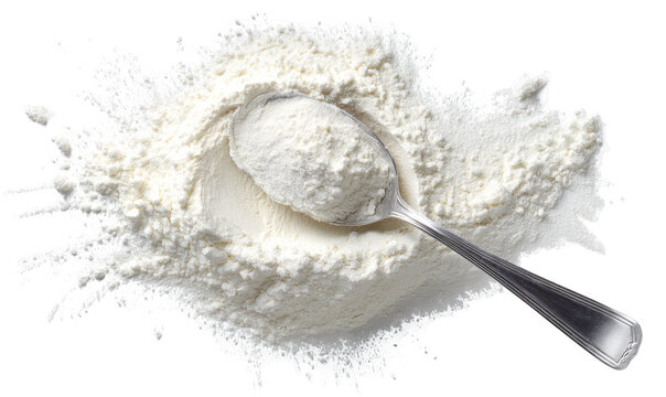 Flour spills around a metal spoon filled with flour