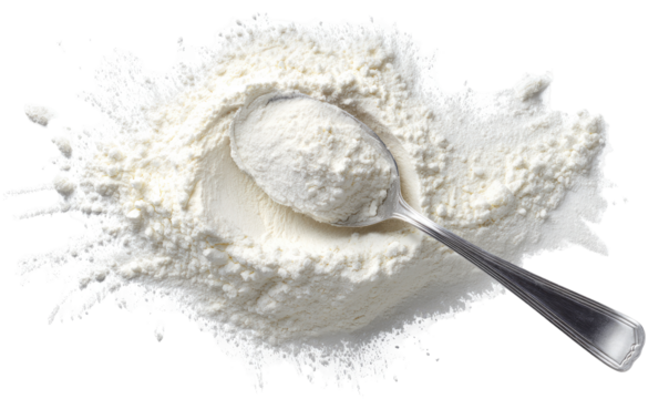 Flour spills around a metal spoon filled with flour